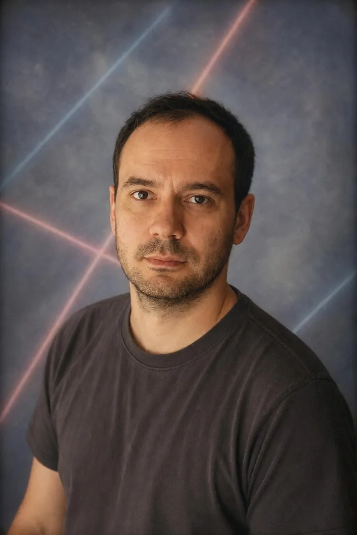 The same man in a 90s school yearbook portrait against a blue backdrop with laser lines.